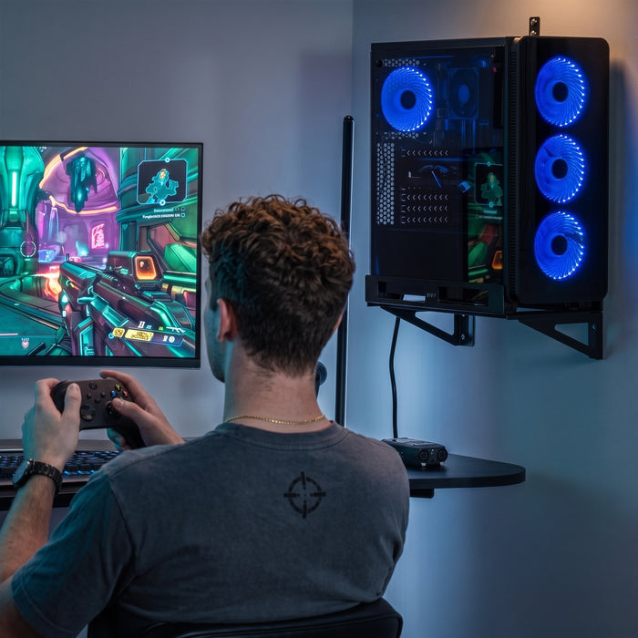 Adjustable PC wall mount holding a gaming computer tower beside a desk for an organized gaming setup