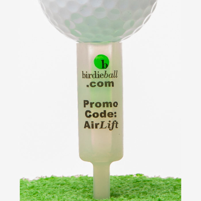 Close-up of a golf ball on a BirdieBall AirLift Tee—an unbreakable, uniform-height golf tee—labeled "birdieball.com Promo Code: AirLift" and resting on green turf.