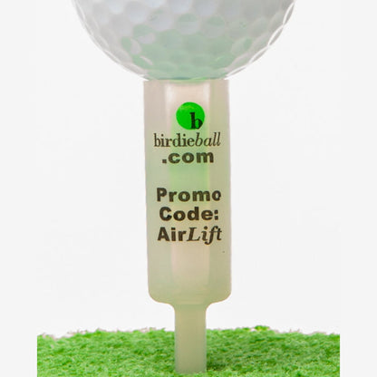Close-up of a golf ball on a BirdieBall AirLift Tee—an unbreakable, uniform-height golf tee—labeled "birdieball.com Promo Code: AirLift" and resting on green turf.