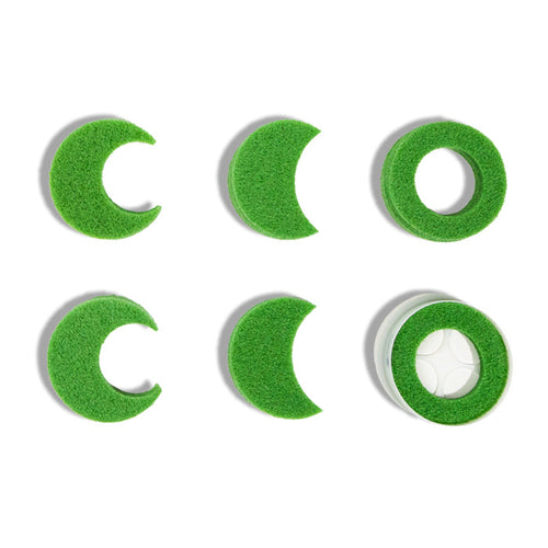Six green BirdieBall Assorted Hole Reduction Inserts & a Double Depth Alignment Cup are arranged in two rows on a white background; one features a white ball, perfect for golf putting training.