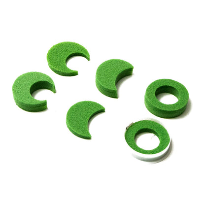 Six green BirdieBall Assorted Hole Reduction Inserts & a Double Depth Alignment Cup, designed to reduce putting hole size for golf training, are arranged on a white background. Some inserts are whole; others feature crescent-shaped cutouts.