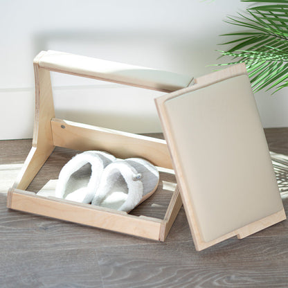 A birch wood footrest with a white cushion on top and storage compartment beneath.
