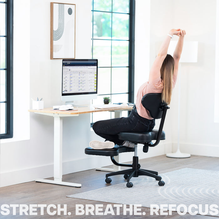Person stretching on an ergonomic chair in a home office setting