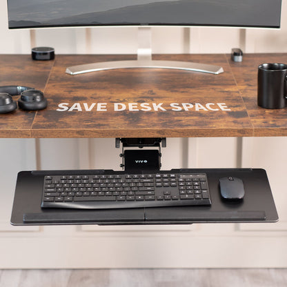 Wooden desk with a monitor, keyboard, and mouse on a light-colored floor.