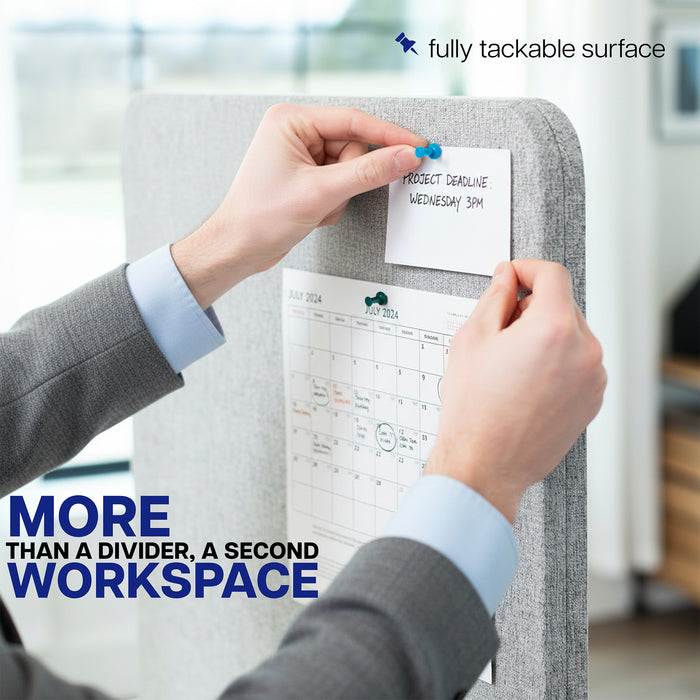 Person attaching a sticky note to a gray desk privacy panel with text 'More than a divider, a second workspace' and 'fully tackable surface'.