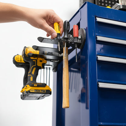 A black magnetic tool organizer mounted on a blue tool cabinet, with a hand adjusting the holder.