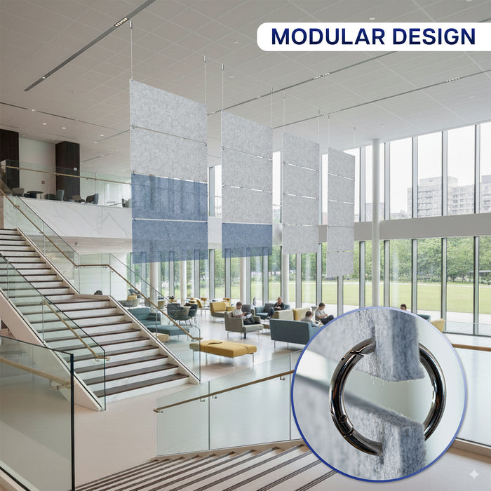 Modern office interior with modular design elements, including a staircase and glass walls and hanging panels above.
