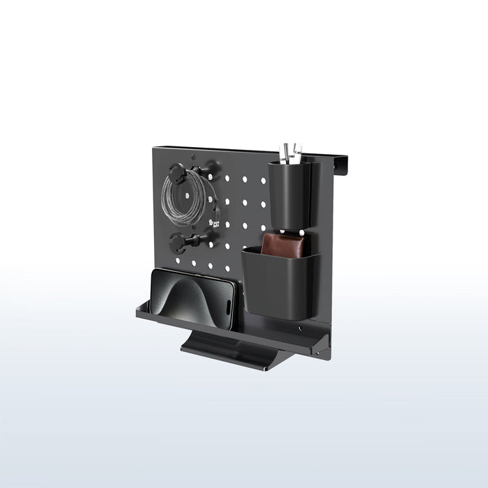 A black pegboard desk organizer with various slots and holders for office supplies and a mobile phone.