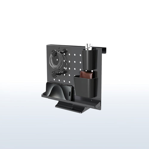 A black pegboard desk organizer with various slots and holders for office supplies and a mobile phone.