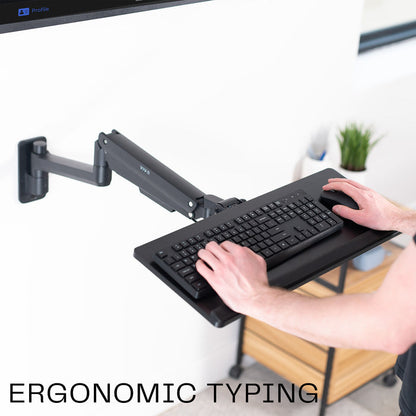 A wall mounted keyboard tray with a pneumatic mechanism