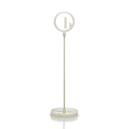 The BirdieBall Putting Green Cups and Flags (Options Available) features a white plastic stand with a round frame holding a lowercase "b," making it an ideal accessory or replacement for your BirdieBall putting green.