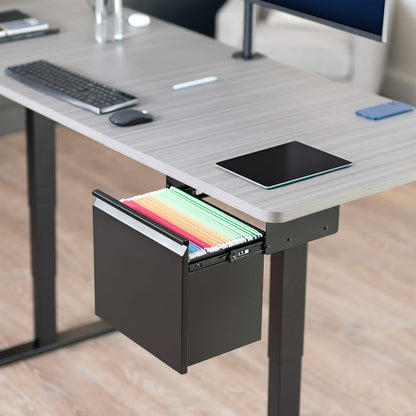 Desk with an under desk filing cabinet with drawer open, revealing colorful folders inside, on a wooden floor.